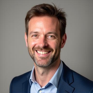 Professional headshot of David Shaw, a travel designer, with a keen and friendly expression